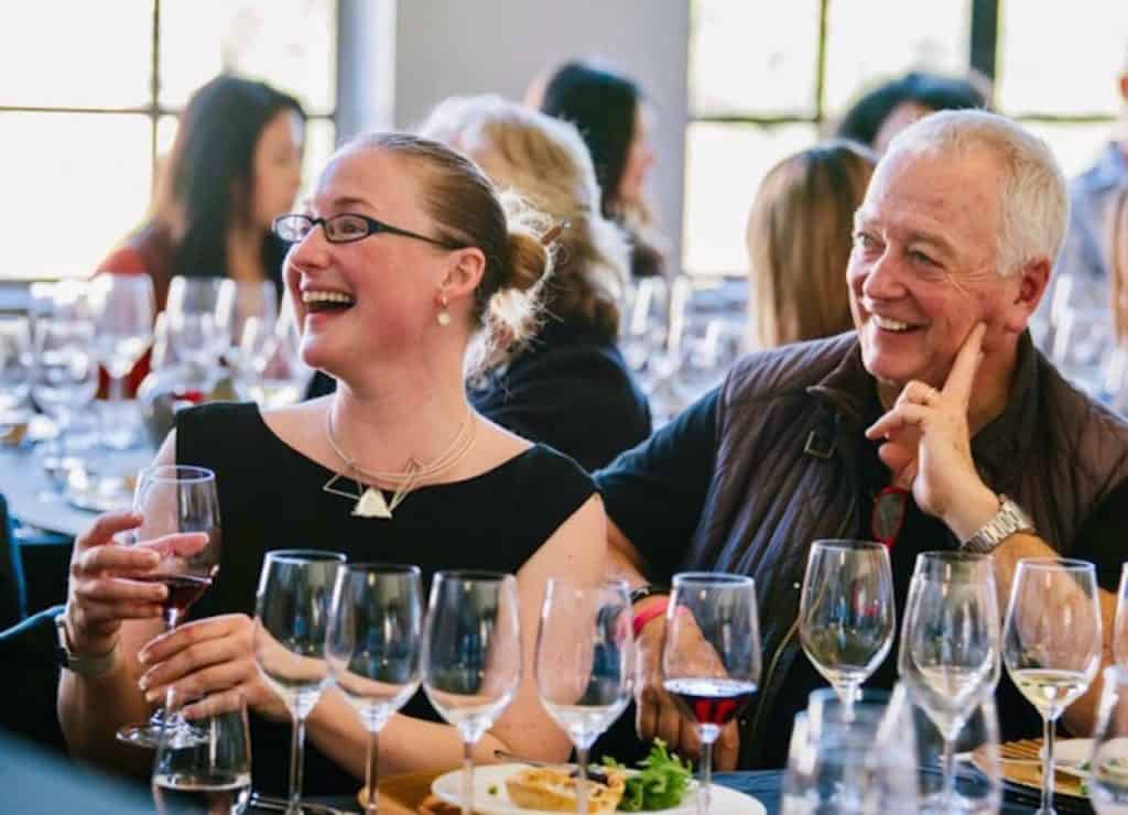 Happy people enjoying wine at a social gathering.